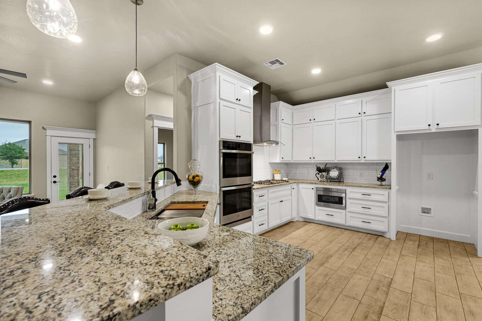 New construction in Lawton — kitchen with white cabinets and granite