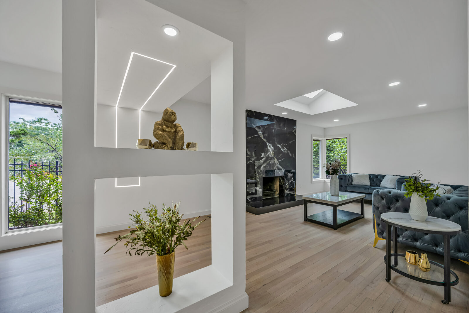 Modern estate in Nichols Hills — black marble fireplace living room